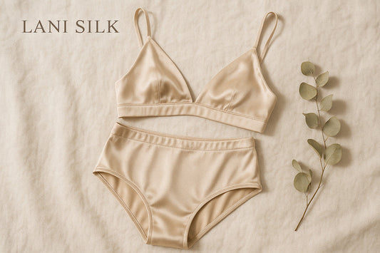 Silk lingerie set in champagne color on neutral fabric background